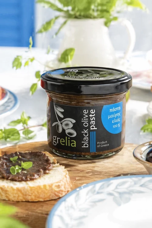 Słoiczek tapenady z czarnych oliwek z pieczywem i oliwkami