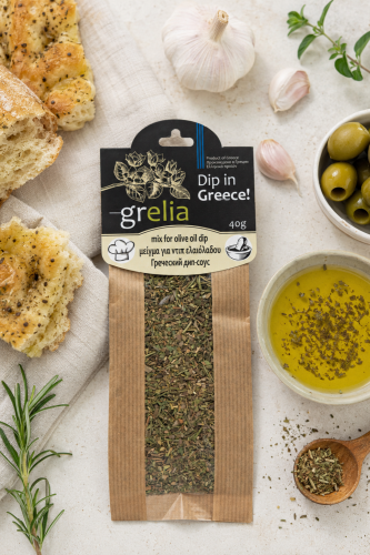 Grecki mix ziół do oliwy 40 g obok miseczki z oliwą i pieczywem