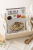 Opakowanie risotto z truflami Zigante w prezentowym pudełku obok łyżki.