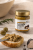 Grecka pasta oliwkowa z czarną truflą Physis podana z crostini na jasnym talerzu